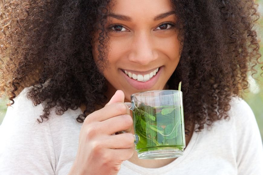 Young Woman Drinking Mint tea outdoor